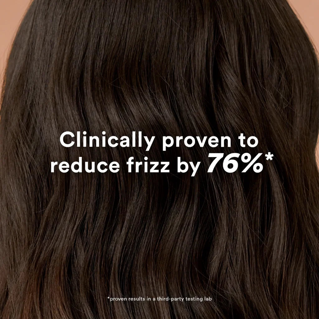 Close-up of dark brown hair with text claiming to reduce frizz by 76%.