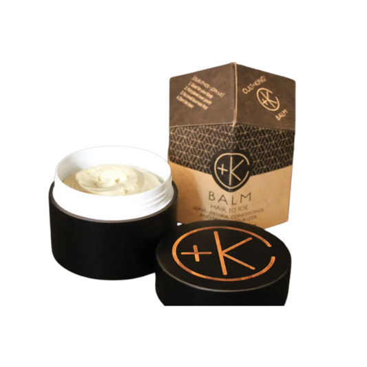 Open balm container with lid and packaging on a white background