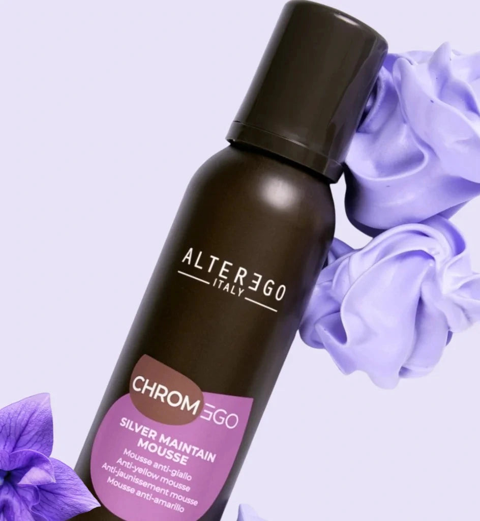 Brown bottle of Alter ego Italy ChromEgo Silver Maintain Mousse with purple flowers on a light purple background