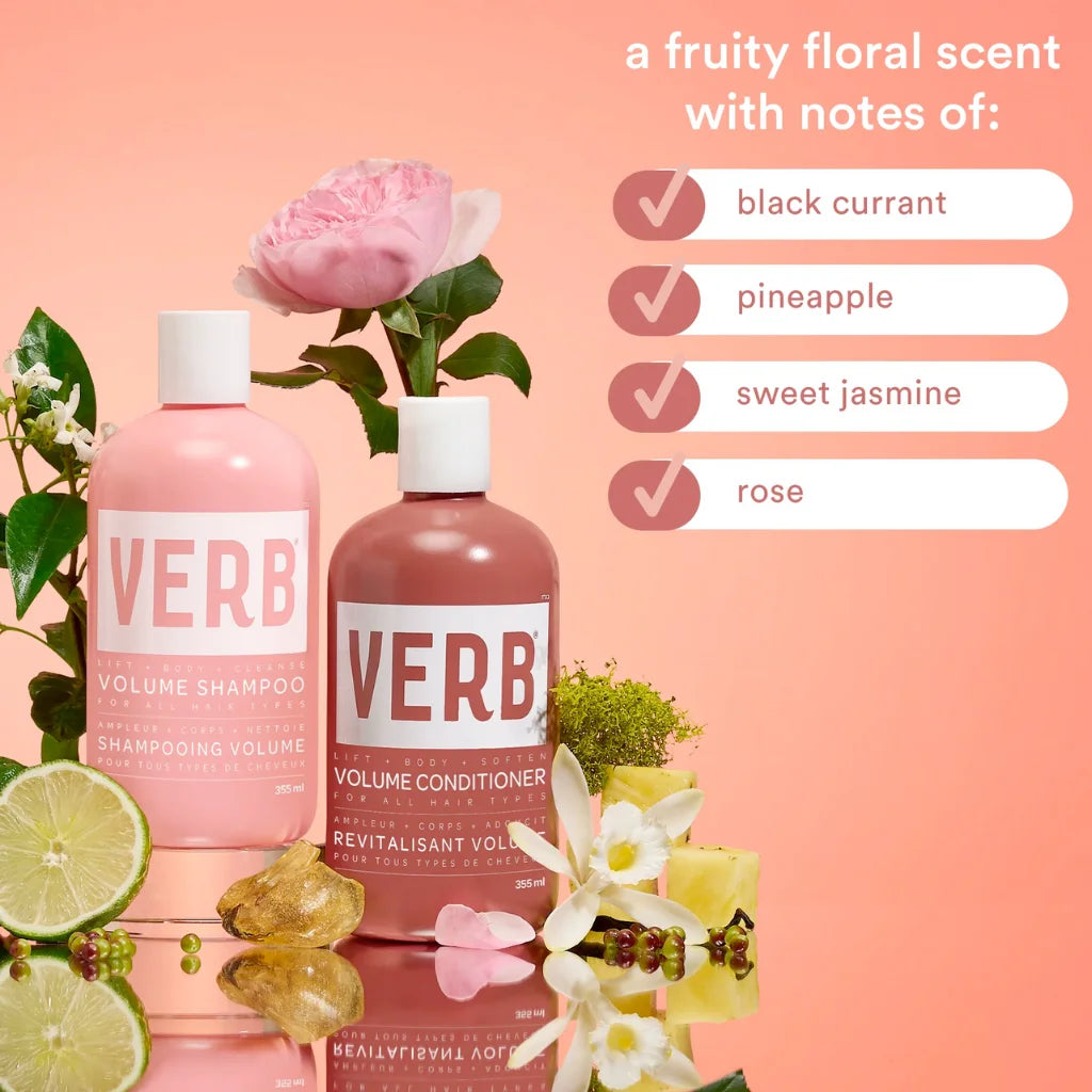 Verb shampoo and conditioner bottles with flowers and fruits on a peach background