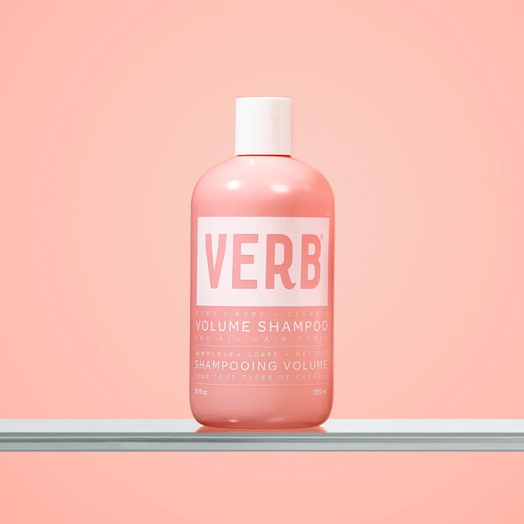 Pink shampoo bottle labeled 'VERB' on a pink background
