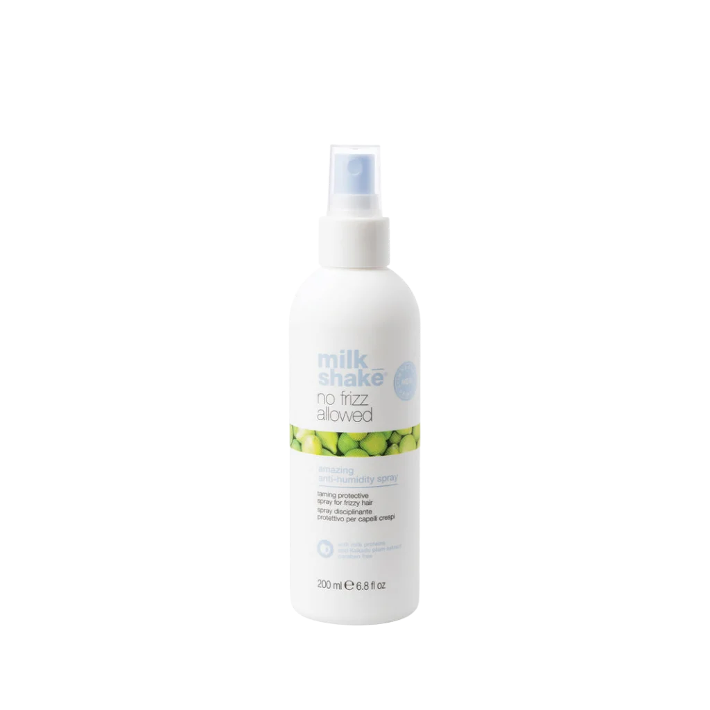 A 200 ml white spray bottle of Milk Shake No Frost Allowed cooling mist, featuring a white pump dispenser and a label with green citrus graphics, set against a plain white background.