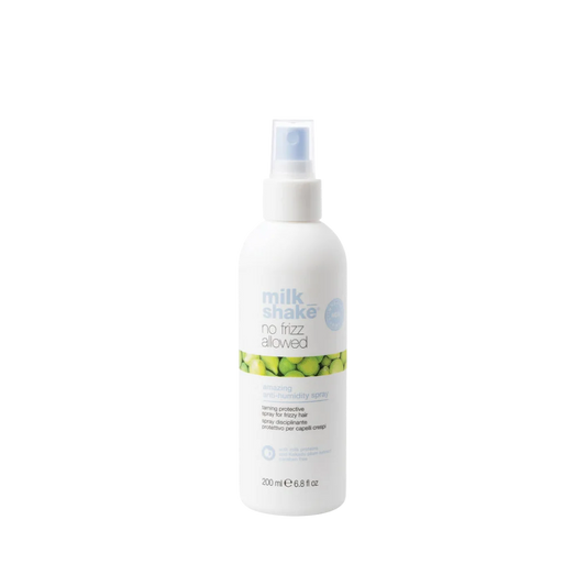 A 200 ml white spray bottle of Milk Shake No Frost Allowed cooling mist, featuring a white pump dispenser and a label with green citrus graphics, set against a plain white background.