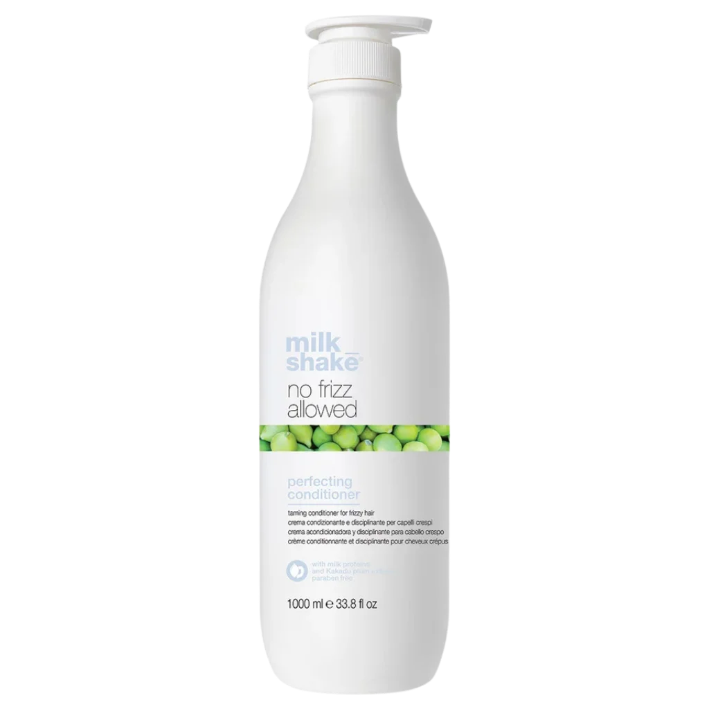 A 1000 ml white pump bottle of Milk Shake No Frizz Allowed Perfecting Conditioner, featuring a green and white label with a green berry pattern, on a solid white background.