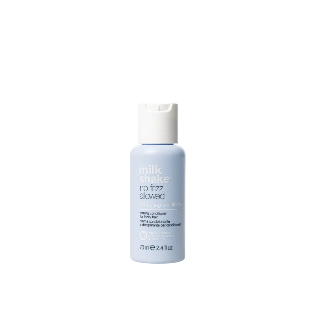 A bottle of Milk Shake No Frizz Allowed Toning Conditioner for silky hair, featuring a light blue bottle and a white cap, centered on a plain white background.