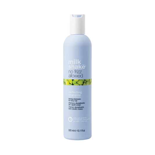 A 300 ml bottle of Milk Shake No Fizz Allowed Perfecting Shampoo, featuring a light blue bottle with a white cap and a green and yellow pattern band on the label, set against a plain white background.